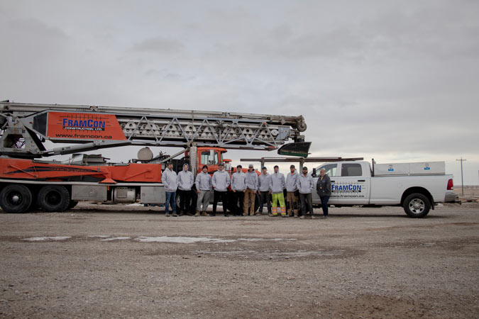the framcon team standing in front of their work vehicles